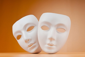 Theatre concept with masks against background