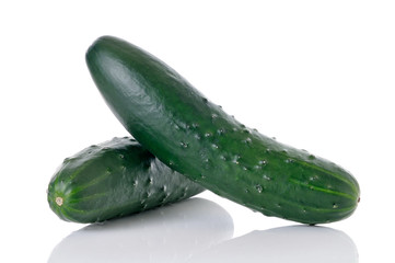 Two whole cucumbers on white background
