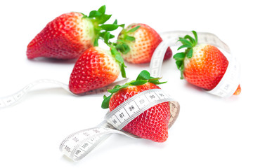 big juicy red ripe strawberries and measure tape isolated on whi