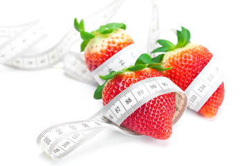 big juicy red ripe strawberries and measure tape isolated on whi