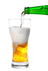 Beer pouring from green bottle into glass isolated on white