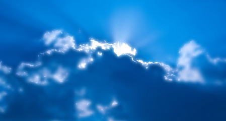 Naklejka na ściany i meble abstract sun rays through the clouds on the sky