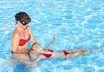 Swimming Instructor learn child swim.