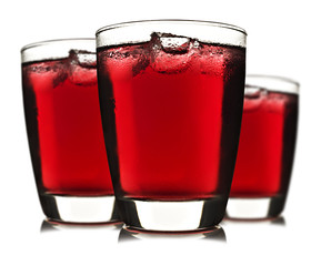 Three glasses of red fruit juice with ice