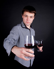 Handsome romantic young man holding wine bottle