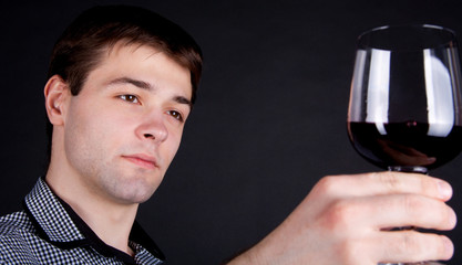 Man evaluating quality red wine