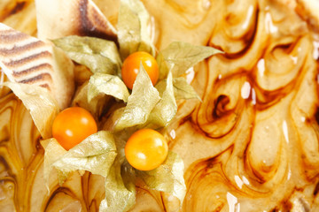 closeup of caramel pie with decorative berries