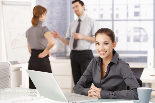 Attractive businesswoman smiling happily in office