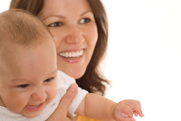 mother stands and holds the baby