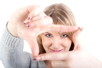 Young attractive woman frmaing her hands, clear vision, isolated