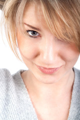 Close-up of beautiful attractive woman, sly glance, smiling