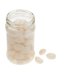 A jar of garlic pieces isolated