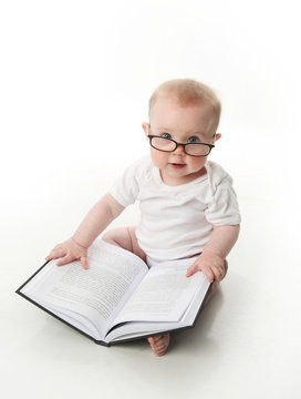 Baby reading with glasses