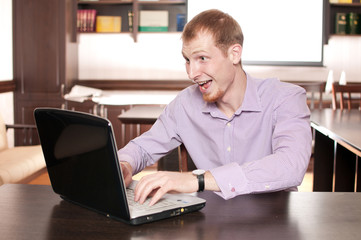 Emotional businessman with laptop