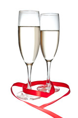 Glasses with Champagne and red ribbon isolated on white