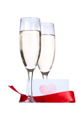 Glasses with Champagne and invitation card isolated on white