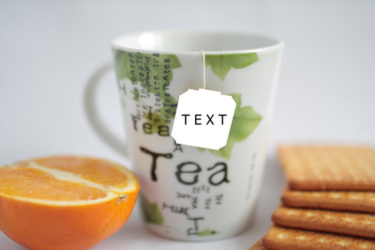Fototapeta ceramic cup for tea, oranges and crackers