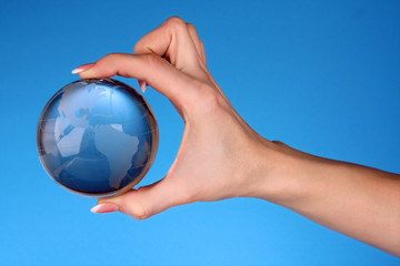 Crystal ball on hand. blue background