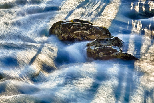 Raging River Flows Around Rocks