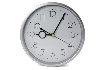 silver wall clock  over a white background