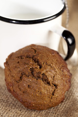 soft ginger cookie with milk in white enamel mug