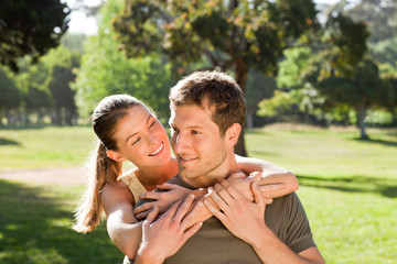 Fototapeta premium Woman hugging her handsome husband