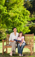Fototapeta premium Mother and her daughter reading a book