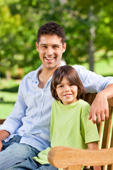 Son with his father on the bench