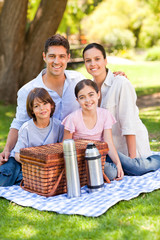 Happy family picnicking in the park