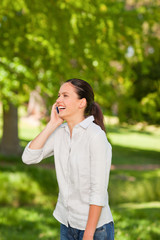 Young woman phoning in the park