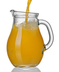 Orange juice flows in jug