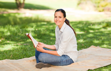 Fototapeta na wymiar Woman reading in the park