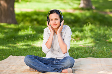 Happy young woman listening to music