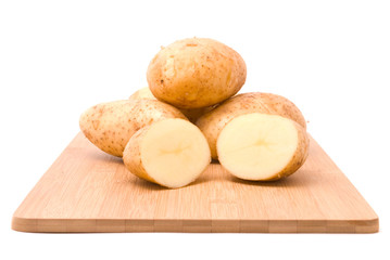 Fresh potatoes with board on a white background