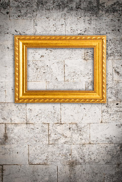 Gold frame on a old wall background