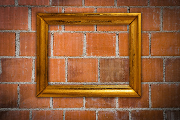 Gold frame on a old wall background