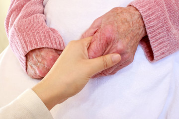 Old and Young Hands on White Blanket