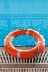 lifebuoy in blue water in swimming pool