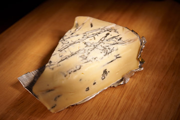 Blue cheese on wooden plank