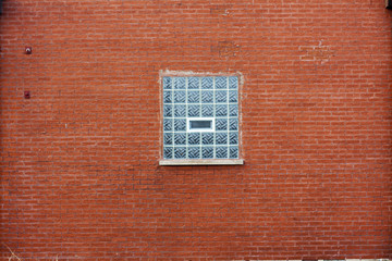 Industrial Red Brick Wall with Blue Glass Block Window