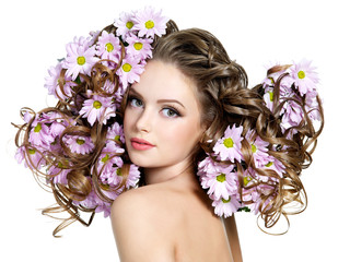 Flowers in long hair of beautiful and sexy woman
