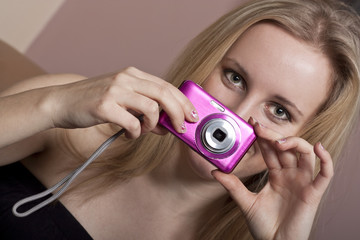 Young blonde girl with a photo camera