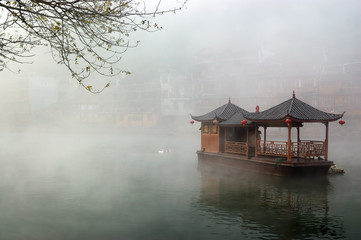 Fototapeta premium China landscape of boat on foggy river