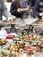 People choosing food from buffet