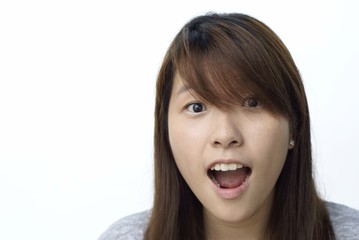 Young chinese lady with surprised look on white