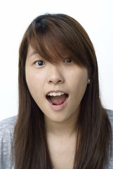 Young chinese lady with surprised look on white