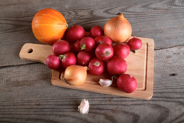 Onions garlic  garden radish on a table