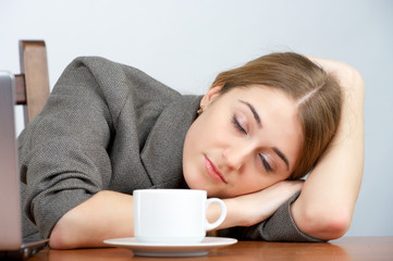 Beautiful businesswoman sleeping at her workplace