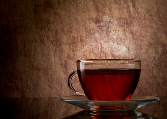 tea in glass cup on old stone  background