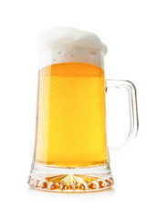 Beer into glass isolated on white